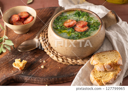 Caldo verde popular soup in Portuguese cuisine. Traditional ingredients for caldo verde are potatoes, onion, garlic, collard greens, chorizo , olive oil and salt. Is a comfort soup and is typically 127799965