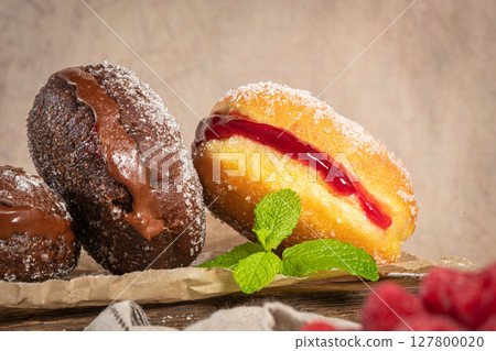 Bolas de Berlim, or "Berlin Balls". Portuguese fried dough with sugar, Filled with chocolate or raspberry jam. Portuguese fried dough with sugar. Chocolate and beetroot berliner Pancakes Doughnuts Bolas de Berlim, or "Berlin Balls". Portuguese fried dough with sugar, Filled with chocolate or raspberry jam. Portuguese fried dough with sugar. Chocolate and beetroot berliner Pancakes Doughnuts 127800020