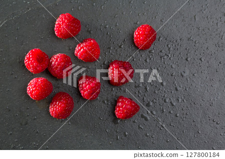 berries raspberry on black slate background berries raspberry on black slate background 127800184