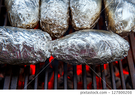 grilled whole potatoes with foil 127800208