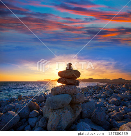 Ibiza Cap des Falco beach sunset with desire stones Ibiza Cap des Falco beach sunset with desire stones 127800289