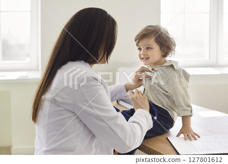 Pediatrician, medical doctor care of infant, children, female healthcare professional at work 127801612