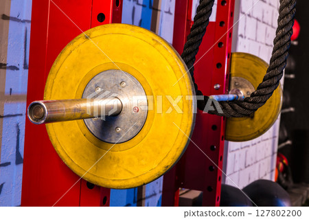 Barbells in a gym bar bells and rope Barbells in a gym bar bells and rope 127802200