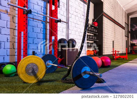 Barbells in a gym bar bells and rope Barbells in a gym bar bells and rope 127802201