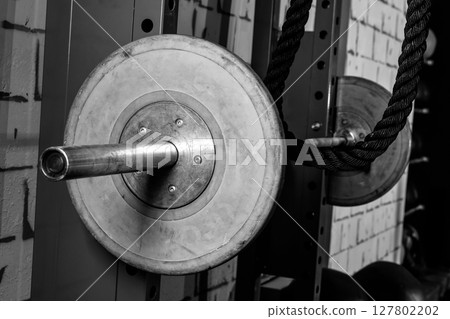 Barbells in a gym bar bells and rope Barbells in a gym bar bells and rope 127802202