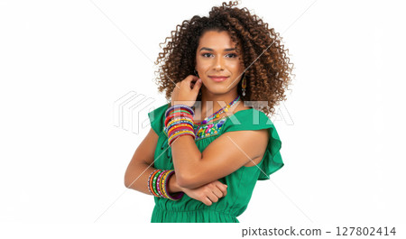 Confident Afro Latina Woman in Green Dress Posing with Colorful Bangles and Curly Hair 127802414