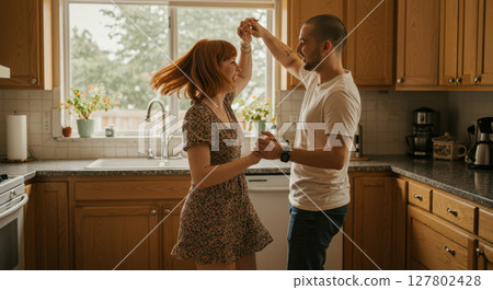 Happy Young Couple Dancing in Kitchen During Cozy Morning Happy Young Couple Dancing in Kitchen During Cozy Morning 127802428