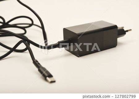 A new charger for gadgets with a wire. USB charging with a wire. A new charger for gadgets with a wire. USB charging with a wire. 127802799