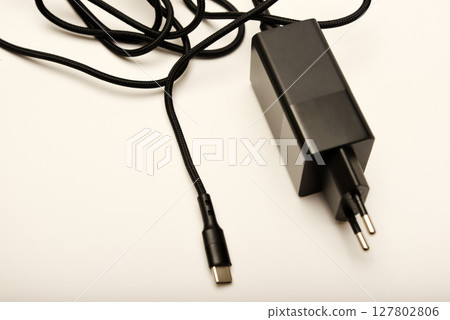 A new charger for gadgets with a wire. USB charging with a wire. A new charger for gadgets with a wire. USB charging with a wire. 127802806