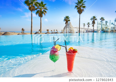 Tropical cocktails in resort infinity pool Tropical cocktails in resort infinity pool 127802843