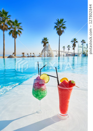 Tropical cocktails in resort infinity pool Tropical cocktails in resort infinity pool 127802844