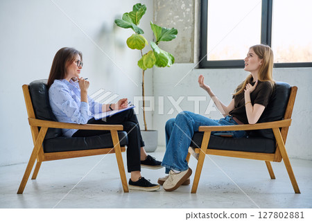 Mental therapy session, female professional psychologist working with young woman patient Mental therapy session, female professional psychologist working with young woman patient 127802881