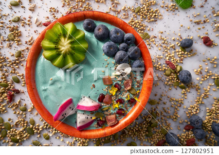 Acai bowl smoothie with kiwi blueberry seeds 127802951