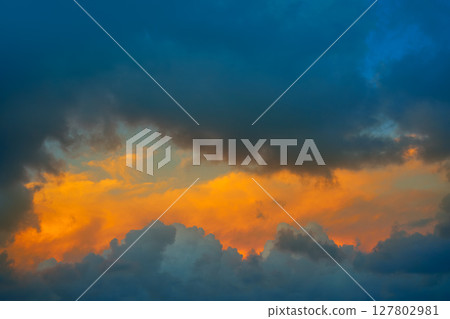 Dramatic clouds at sunset orange sky 127802981