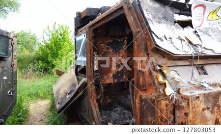 Rusty and burned-out armored vehicles on ukrainian territory. Exhibition of destroyed military equipment of the russian army. War between Ukraine and russia. Close up Slow motion 127803053
