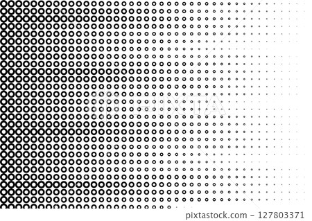 Abstract halftone background with black circular ring shapes fading across white surface. 127803371