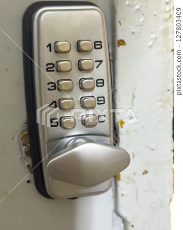 Combination lock on the door Combination lock on the door 127803409