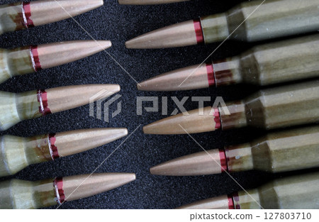 Rifle Bullets In Head To Head Order Closeup View. Stock Photo For Military Backgrounds Rifle Bullets In Head To Head Order Closeup View. Stock Photo For Military Backgrounds 127803710