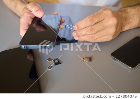 Detailed Process of Installing a SIM Card Utilizing Various Smartphone Components and Accessories Detailed Process of Installing a SIM Card Utilizing Various Smartphone Components and Accessories 127804079