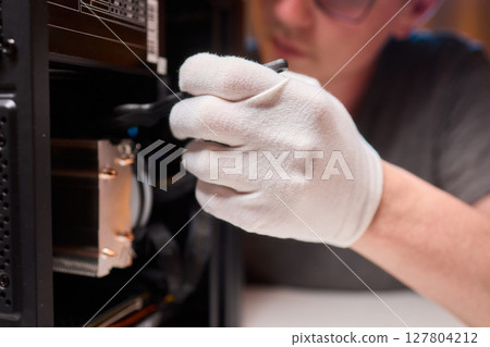Cleaning a processor fan with a brush Cleaning a processor fan with a brush 127804212