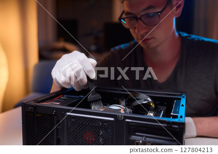 Cleaning a processor fan with a brush Cleaning a processor fan with a brush 127804213