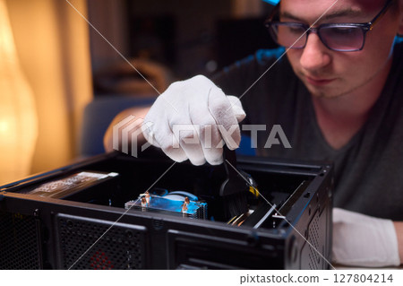 Cleaning a processor fan with a brush 127804214