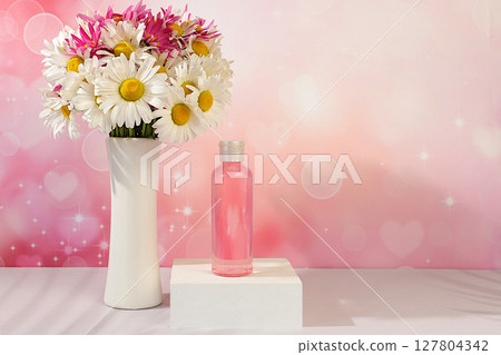 Wellness composition with rose water and fresh flowers of garden chamomile and mallow, spa salon advertising card, natural self-care and healthy lifestyle concept, abstract composition with flowers. 127804342