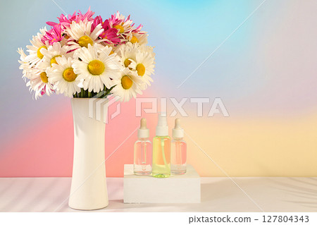 Wellness composition with cosmetic water and fresh flowers of garden chamomile and mallow, spa salon advertising card,natural self-care and healthy lifestyle concept, abstract composition with flowers 127804343