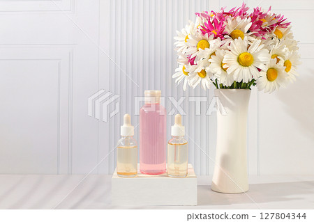 Wellness composition with cosmetic water and fresh flowers of garden chamomile and mallow, spa salon advertising card,natural self-care and healthy lifestyle concept, abstract composition with flowers Wellness composition with cosmetic water and fresh flowers of garden chamomile and mallow, spa salon advertising card,natural self-care and healthy lifestyle concept, abstract composition with flowers 127804344