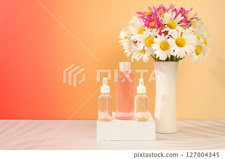 Wellness composition with cosmetic water and fresh flowers of garden chamomile and mallow, spa salon advertising card,natural self-care and healthy lifestyle concept, abstract composition with flowers Wellness composition with cosmetic water and fresh flowers of garden chamomile and mallow, spa salon advertising card,natural self-care and healthy lifestyle concept, abstract composition with flowers 127804345