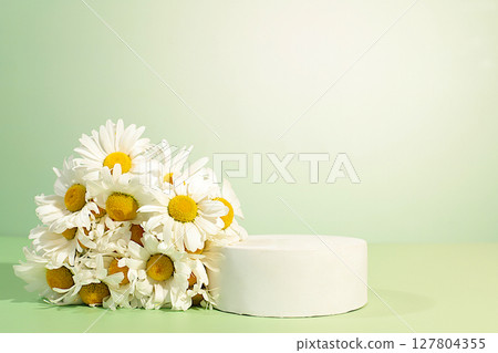 Empty podium with beautiful flowers of garden chamomile and mallow.Abstract flower arrangement,banner.Creative template for your design.Minimal modern aesthetics, elegant beauty concept 127804355