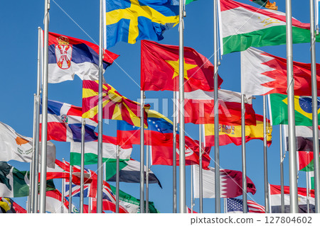 Lots of world's countries national flags waving on the wind, with Sweden, Sri Lankan, Macedonian, Tajik, Serbian, Dominican, Polish, Bahrain banners in the foreground, Doha, Qatar Lots of world's countries national flags waving on the wind, with Sweden, Sri Lankan, Macedonian, Tajik, Serbian, Dominican, Polish, Bahrain banners in the foreground, Doha, Qatar 127804602