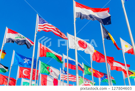 World summit countries national flags waving together on the wind, with American, Japanese, Omani, Chinese, Russian, Iraqi, Egyptian, Somalian, Turkey, Algerian banners waving in the foreground, Doha 127804603