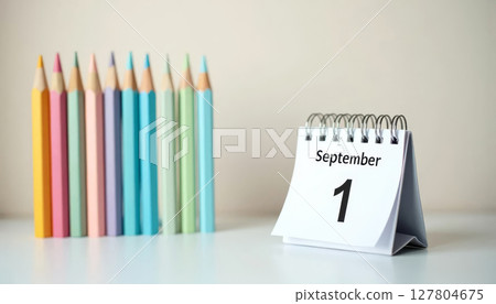 September 1 calendar and pastel pencils on desk. First day of school, new academic year, learning start. 127804675