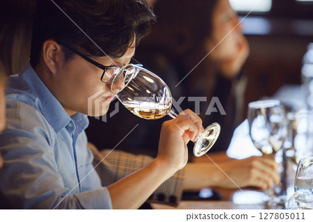 Man Smelling Wine During Sommelier Tasting Man Smelling Wine During Sommelier Tasting 127805011