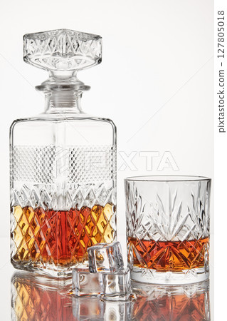 Scotch with ice cubes in glassware. Alcoholic drink. 127805018