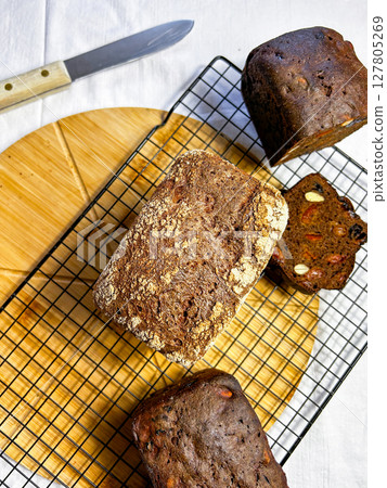 Artisanal gluten free bread held with care. Perfect for small bakery branding, social media, and rustic cooking scenes. Artisanal gluten free bread held with care. Perfect for small bakery branding, social media, and rustic cooking scenes. 127805269