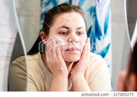 Morning skincare routine: woman doing first step of face skin cleansing routine. Relatable content for skincare. International self care day. Morning skincare routine: woman doing first step of face skin cleansing routine. Relatable content for skincare. International self care day. 127805275