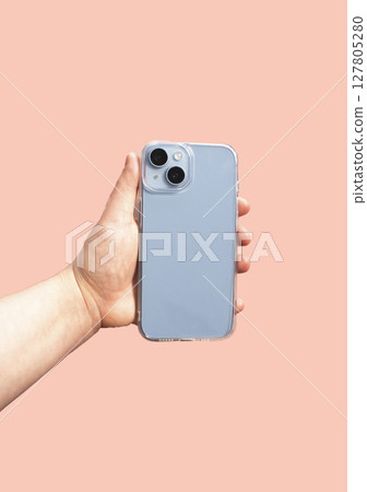 Transparent phone case held in hand, showcasing clean design against pastel background. Ideal for showcasing product features and benefits 127805280