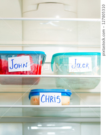 Meal prep containers in office refrigerator. Ideal for time management content, and efficient workspace setups. Meal prep containers in office refrigerator. Ideal for time management content, and efficient workspace setups. 127805310