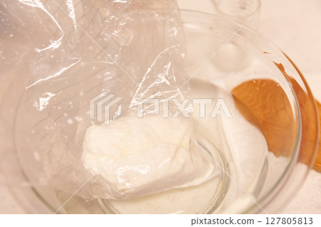 Homemade mozzarella cheese in a glass bowl of water 127805813