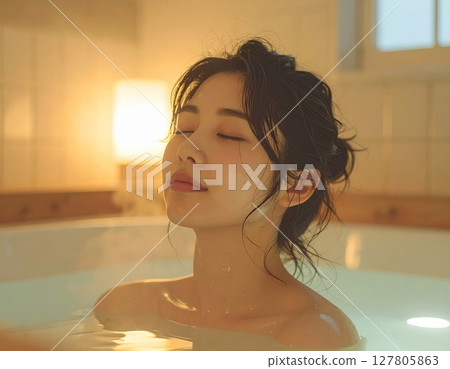 A woman relaxing in the bath 127805863