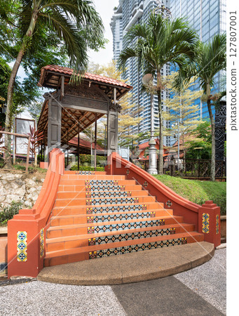 Vibrant tiled stairs at Muzium Negara in Kuala Lumpur, Malaysia, surrounded by lush greenery 127807001