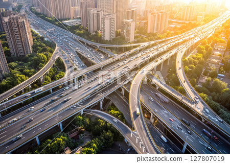 Aerial View of a Busy Urban Highway Interchange with Heavy Traffic Flow During Sunset Aerial View of a Busy Urban Highway Interchange with Heavy Traffic Flow During Sunset 127807019