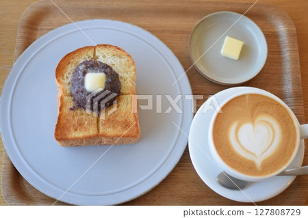Coffee and bread on a white plate Coffee and bread on a white plate 127808729