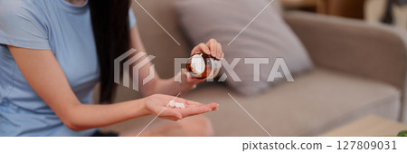 Asian Young Adult Woman's Hands Taking Daily Supplements for Optimal Health and Wellness at Home Promoting Longevity Lifestyle Asian Young Adult Woman's Hands Taking Daily Supplements for Optimal Health and Wellness at Home Promoting Longevity Lifestyle 127809031