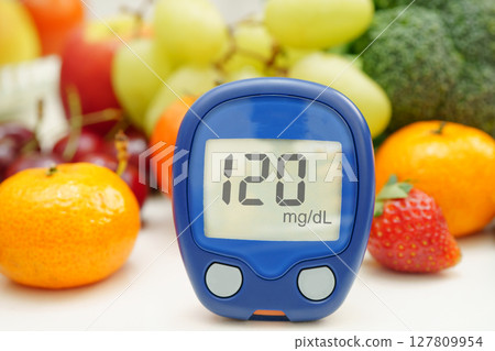 Digital glucose meter for check sample blood sugar level to treatment diabetes with vegetable and fruit healthy. 127809954