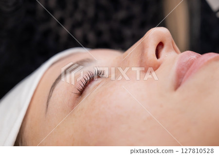 The process of professional eyelash lamination in a salon.  127810528