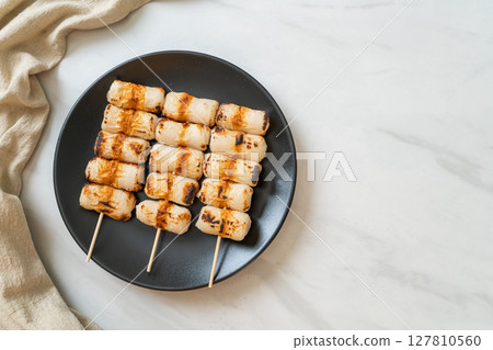 grilled tube shaped fish paste cake skewe or tube squid skewer grilled tube shaped fish paste cake skewe or tube squid skewer 127810560