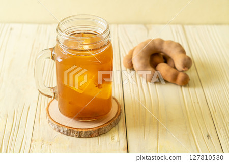 Delicious sweet drink tamarind juice and ice cube 127810580